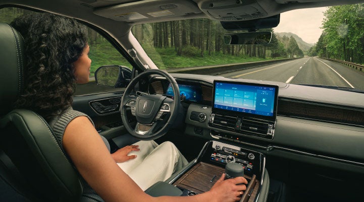 A driver of a Lincoln Navigator® SUV is shown utilizing the Lincoln BlueCruise feature.